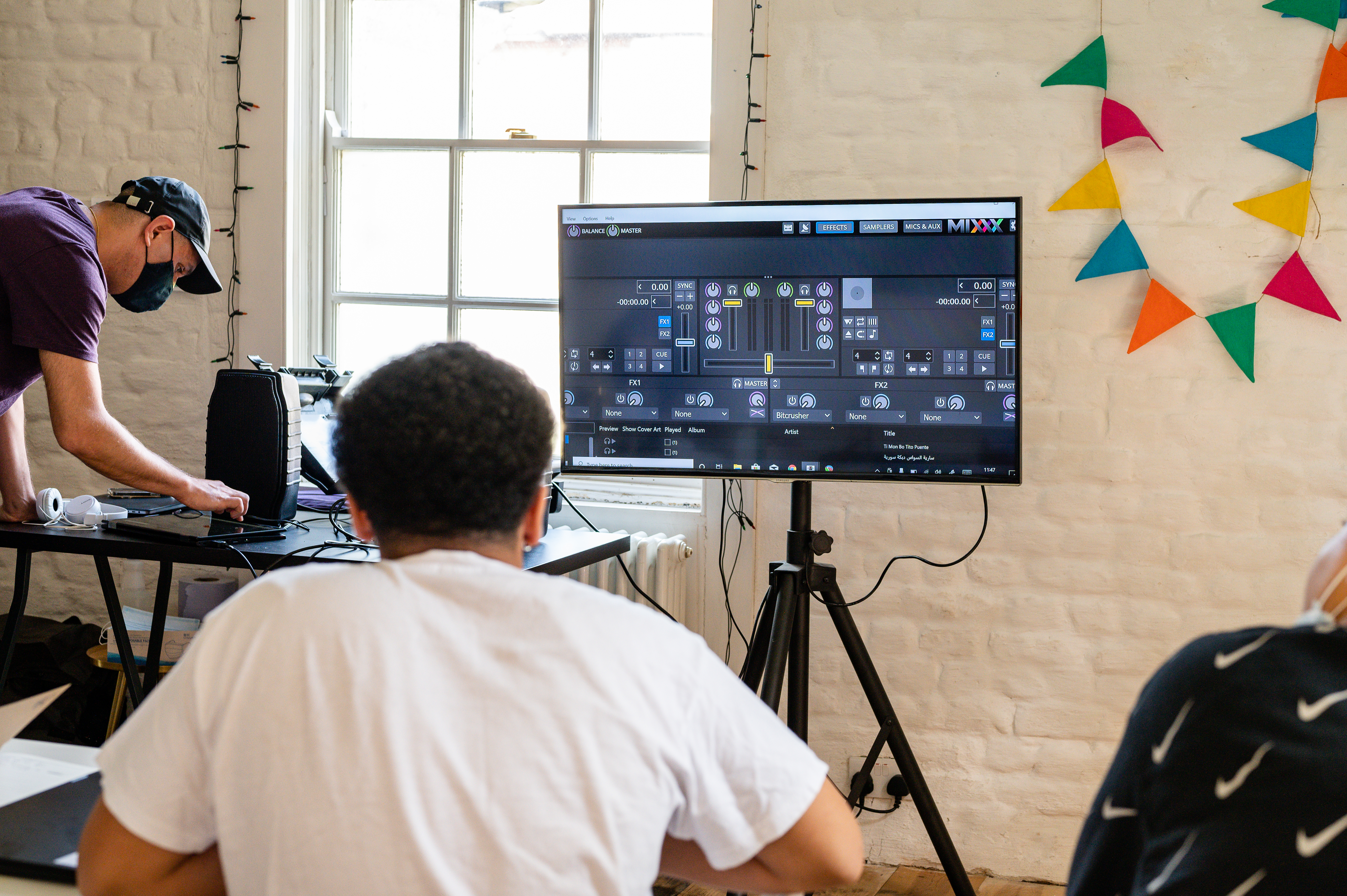 Person looking at monitor with sound editing software on the screen.