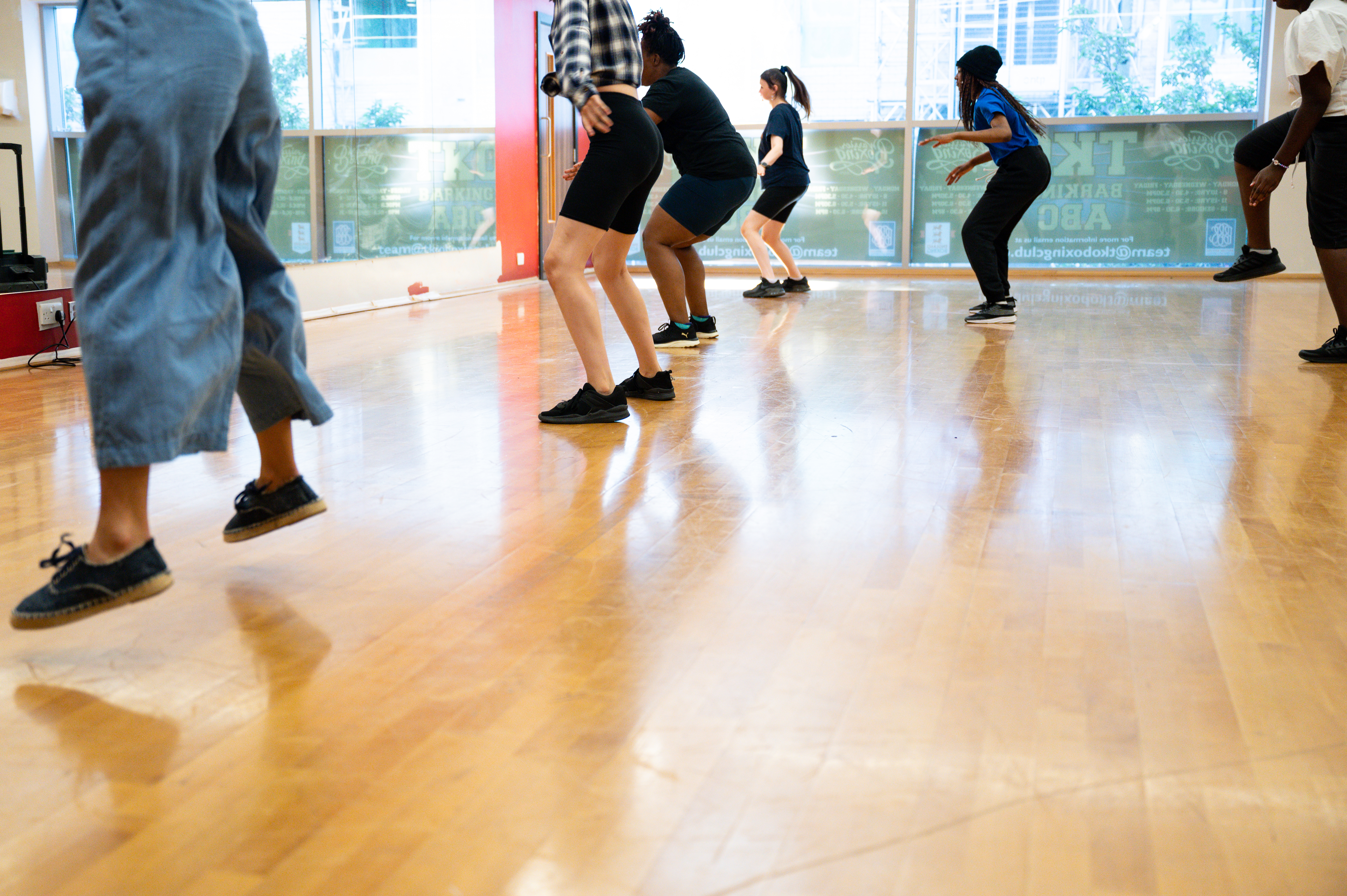 6 young people dancing in front of studio mirror